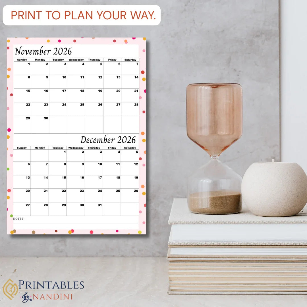 Printable November and December 2026 calendar page with colorful dot border, styled on a modern desk.
