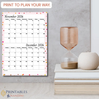 Printable November and December 2026 calendar page with colorful dot border, styled on a modern desk.